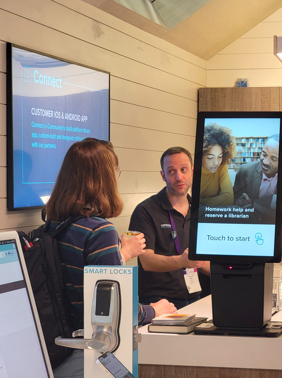Interior photo of tiny library showing a member of Communico talking to a prospective client