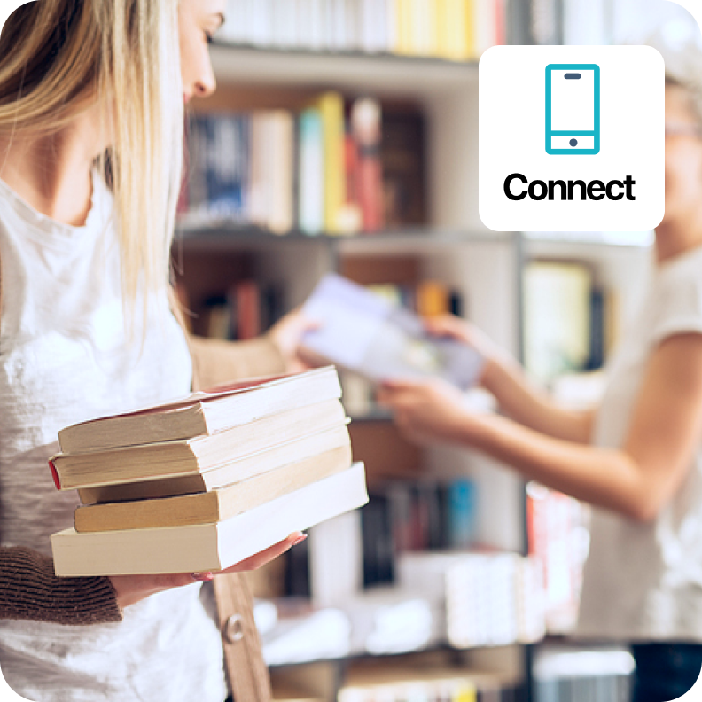 image of a woman holding books in a library