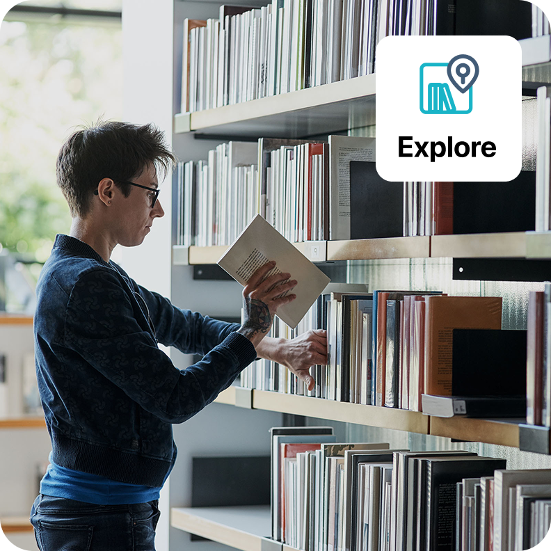 image of staff member putting books back on library shelves